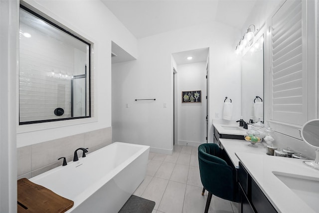 15040 Berry Brook Dr, Conroe, TX 77302 - bathroom featuring a freestanding bath, double vanity, tile patterned floors, and baseboards