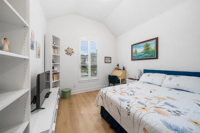 15040 Berry Brook Dr, Conroe, TX 77302 - bedroom with light wood-style flooring, lofted ceiling, and baseboards