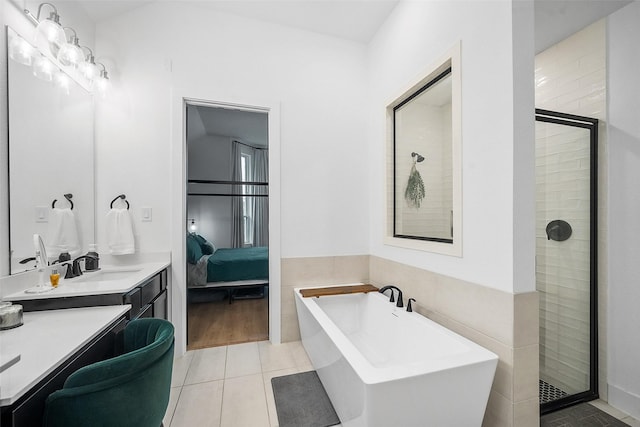 15040 Berry Brook Dr, Conroe, TX 77302 - bathroom featuring a soaking tub, tile patterned flooring, a shower stall, ensuite bathroom, and vanity
