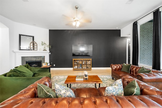 15040 Berry Brook Dr, Conroe, TX 77302 - living area featuring wood finished floors, a fireplace, ceiling fan, baseboards, and arched walkways