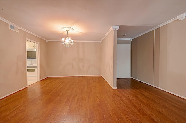 642 S Ripple Creek Dr Unit 642, Houston, TX 77057 - spare room featuring ornamental molding, a chandelier, wood finished floors, and baseboards