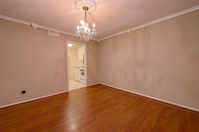 642 S Ripple Creek Dr Unit 642, Houston, TX 77057 - unfurnished room featuring ornamental molding, a chandelier, wood finished floors, and baseboards