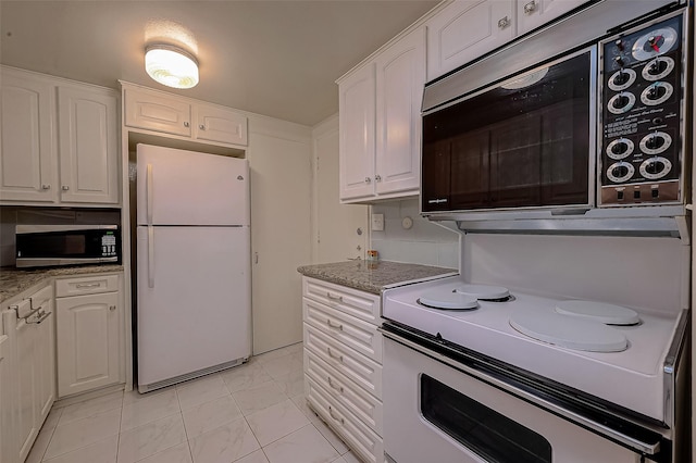 642 S Ripple Creek Dr Unit 642, Houston, TX 77057 - kitchen featuring freestanding refrigerator, stainless steel microwave, white cabinetry, range with electric cooktop, and light stone counters