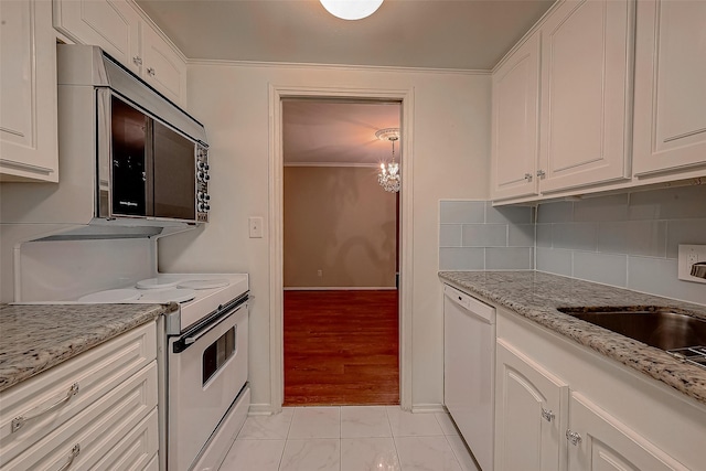 642 S Ripple Creek Dr Unit 642, Houston, TX 77057 - kitchen featuring white appliances, white cabinetry, decorative backsplash, light stone counters, and ornamental molding