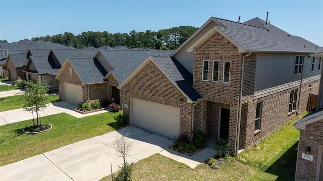 22614 Rosy Heights Trl, Tomball, TX 77377 - traditional-style home with brick siding, a garage, driveway, and a front lawn