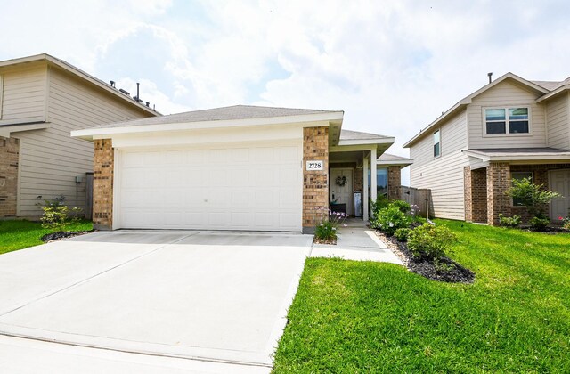 2728 Cadiz Bay Dr, Conroe, TX 77301 - view of front of home featuring driveway, a front lawn, a garage, and brick siding