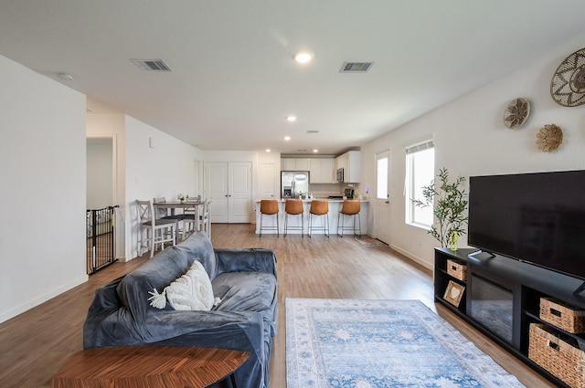 2728 Cadiz Bay Dr, Conroe, TX 77301 - living room featuring light wood-style floors, baseboards, and recessed lighting