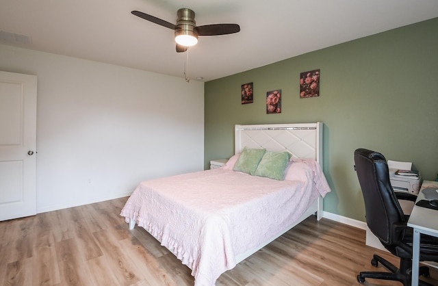 2728 Cadiz Bay Dr, Conroe, TX 77301 - bedroom with wood finished floors, a desk, and a ceiling fan
