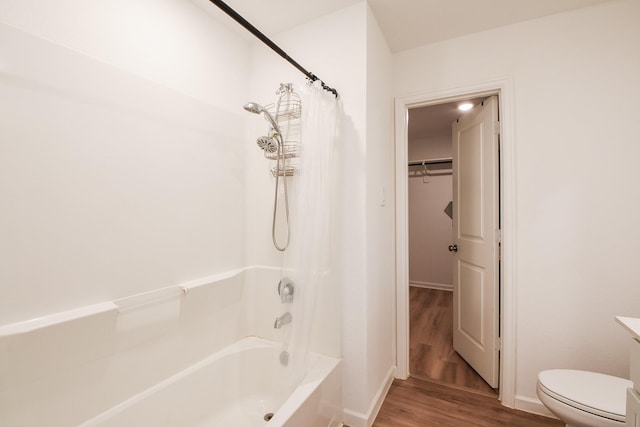 2728 Cadiz Bay Dr, Conroe, TX 77301 - full bath with wood finished floors, toilet, shower / bath combination with curtain, and baseboards