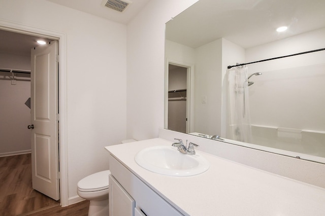 2728 Cadiz Bay Dr, Conroe, TX 77301 - full bath featuring wood finished floors, toilet, a spacious closet, vanity, and recessed lighting
