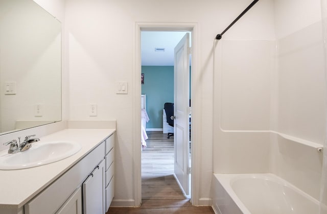 2728 Cadiz Bay Dr, Conroe, TX 77301 - full bathroom with wood finished floors, vanity, baseboards, and bathtub / shower combination
