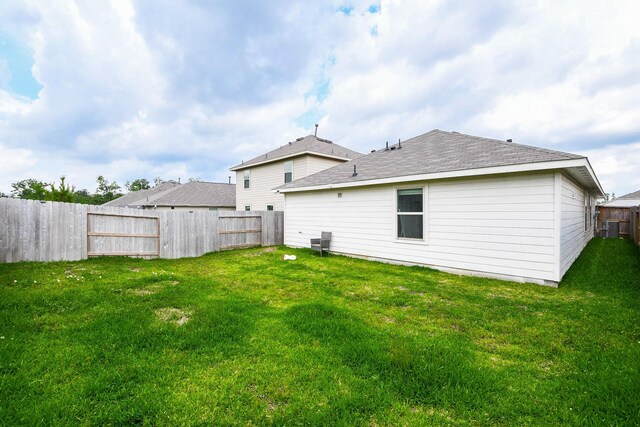 2728 Cadiz Bay Dr, Conroe, TX 77301 - back of property featuring roof with shingles and central AC unit