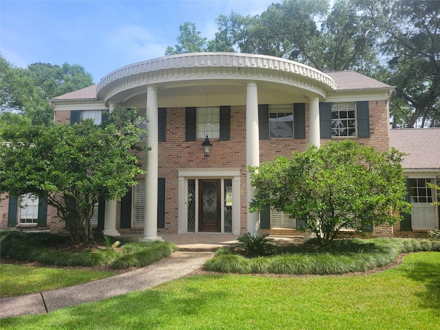 456 Lexington Ct, Conroe, TX 77302 - neoclassical / greek revival house with brick siding, a front yard, and roof with shingles