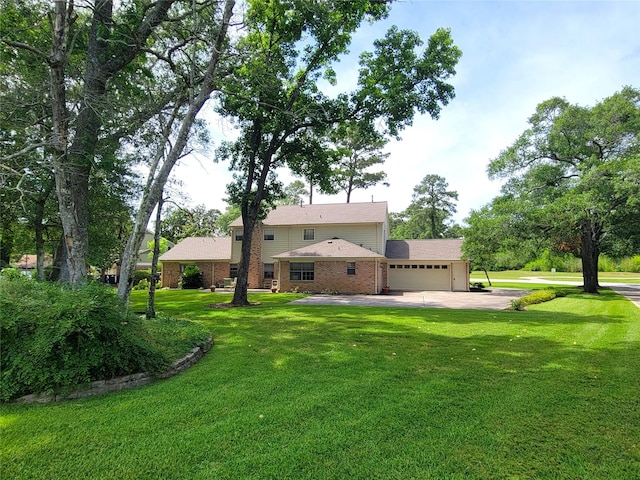 456 Lexington Ct, Conroe, TX 77302 - rear view of house with a garage, a yard, driveway, and brick siding