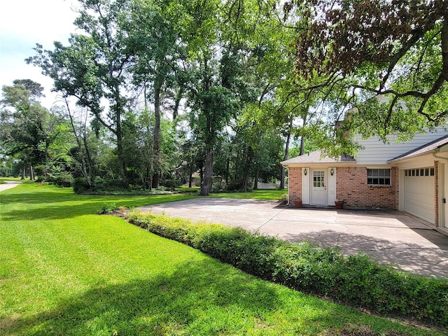 456 Lexington Ct, Conroe, TX 77302 - view of grassy yard with an attached garage and driveway