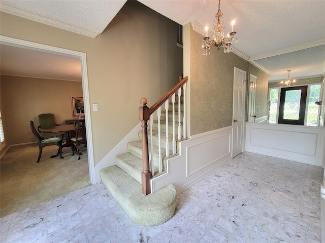 456 Lexington Ct, Conroe, TX 77302 - stairs featuring a chandelier, crown molding, a textured ceiling, a wainscoted wall, and carpet floors