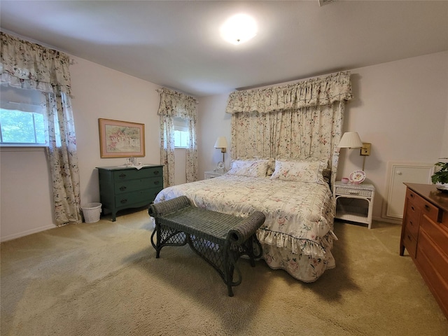 456 Lexington Ct, Conroe, TX 77302 - bedroom with multiple windows, light colored carpet, and baseboards