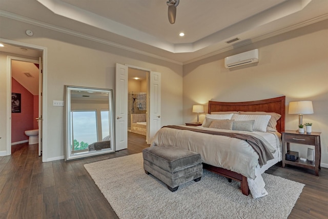 11872 Seashell Cir, Montgomery, TX 77356 - bedroom with a tray ceiling, a wall mounted AC, ensuite bathroom, recessed lighting, and dark wood-style floors