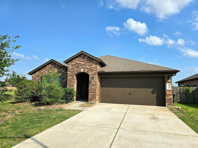 18411 Pelham Hollow Trl, Richmond, TX 77407 - view of front of property featuring brick siding, an attached garage, driveway, and a shingled roof