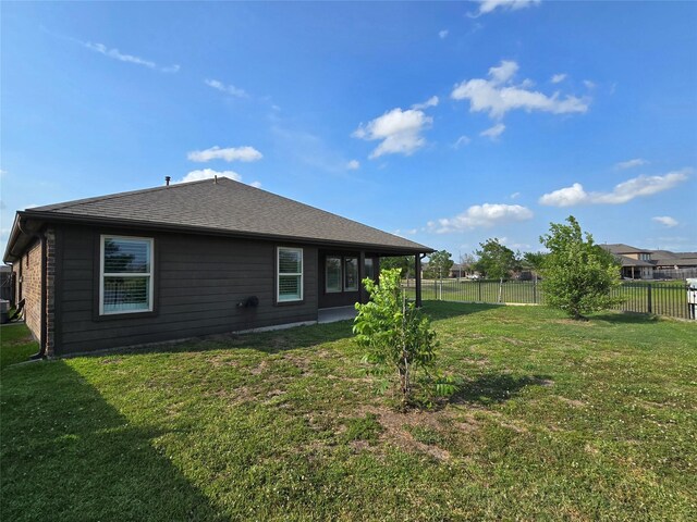 18411 Pelham Hollow Trl, Richmond, TX 77407 - back of house featuring a shingled roof and central AC unit