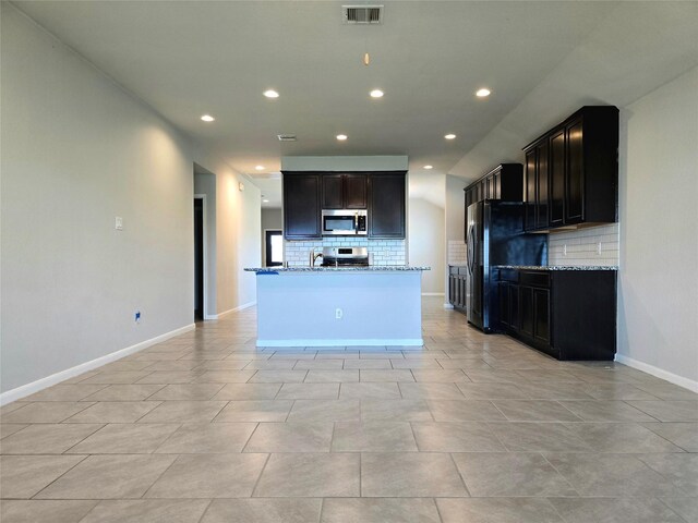 18411 Pelham Hollow Trl, Richmond, TX 77407 - kitchen featuring stainless steel appliances, backsplash, recessed lighting, light stone countertops, and baseboards