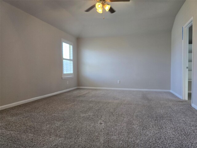 18411 Pelham Hollow Trl, Richmond, TX 77407 - carpeted empty room with a ceiling fan, baseboards, and vaulted ceiling