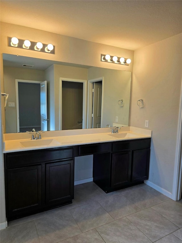 18411 Pelham Hollow Trl, Richmond, TX 77407 - full bathroom with double vanity, tile patterned floors, and baseboards