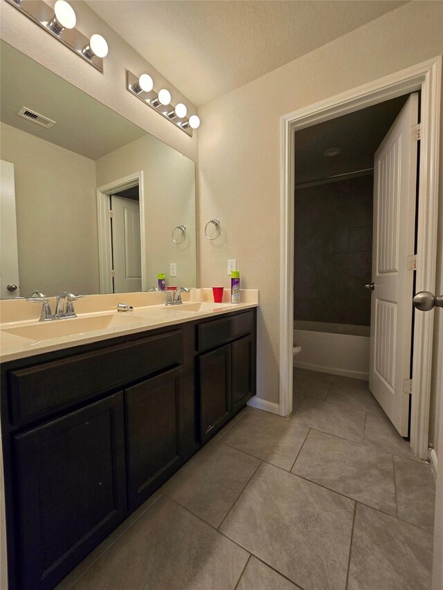 18411 Pelham Hollow Trl, Richmond, TX 77407 - full bathroom featuring double vanity, tile patterned flooring, and toilet