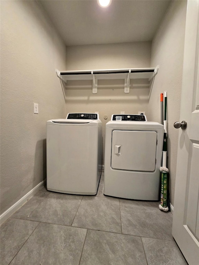 18411 Pelham Hollow Trl, Richmond, TX 77407 - washroom with washing machine and clothes dryer, baseboards, and light tile patterned flooring