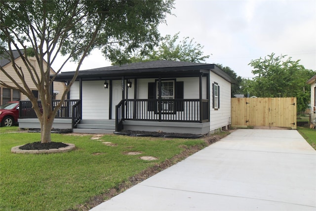 1115 W 4th St, Freeport, TX 77541 - view of front of house with covered porch and concrete driveway