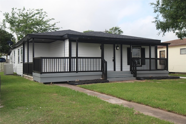 view of front of home with a porch, a front yard, and roof with shingles
