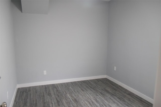 1115 W 4th St, Freeport, TX 77541 - empty room with dark wood finished floors and baseboards