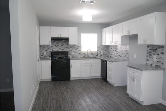 1115 W 4th St, Freeport, TX 77541 - kitchen featuring black appliances, under cabinet range hood, light stone countertops, and white cabinets