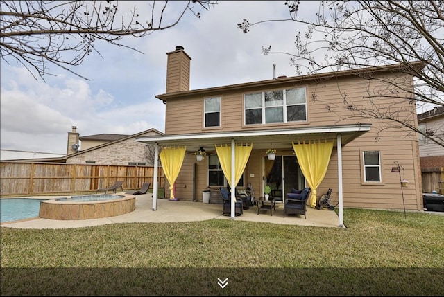 back of house with a patio, an in-ground hot tub, outdoor lounge area, and a chimney