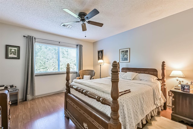 2607 E Pebble Beach Dr, Missouri City, TX 77459 - bedroom featuring baseboards, a textured ceiling, wood finished floors, and ceiling fan