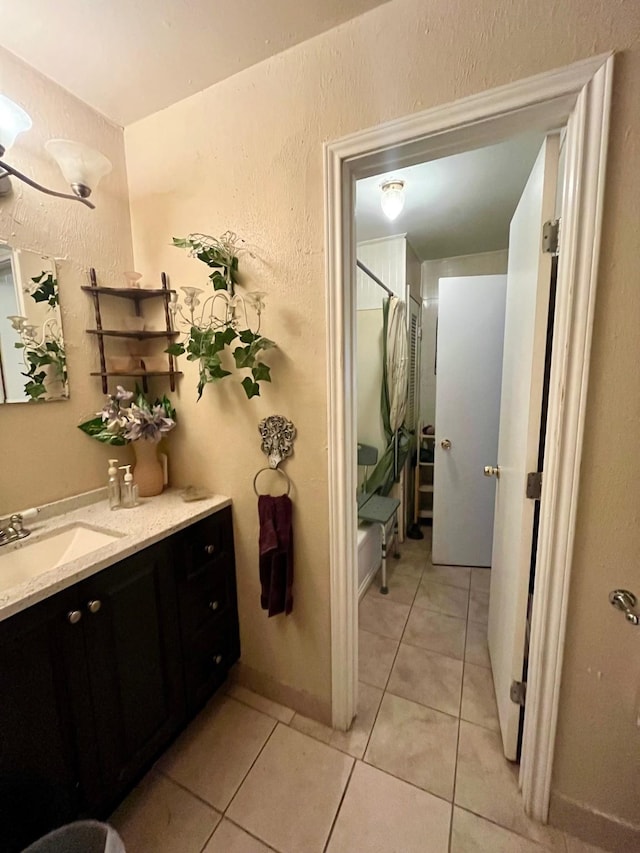 2923 Ellington St, Houston, TX 77088 - full bathroom with vanity, tile patterned flooring, shower / bath combo, and a textured wall
