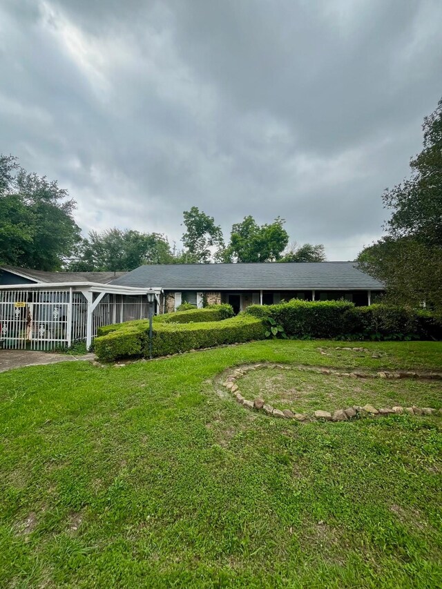 2923 Ellington St, Houston, TX 77088 - view of front of property with a front yard and a sunroom