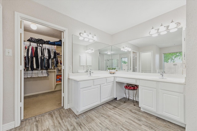 3413 Somerset Ln, Deer Park, TX 77536 - full bathroom with wood finished floors, double vanity, a spacious closet, and baseboards
