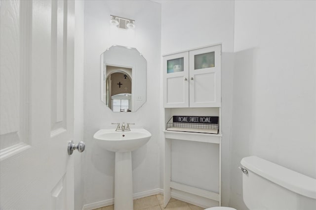 3413 Somerset Ln, Deer Park, TX 77536 - half bathroom featuring toilet, a sink, tile patterned flooring, and baseboards