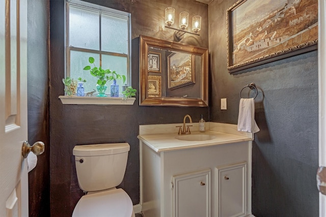 half bathroom featuring toilet and vanity