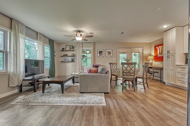 living room with light wood finished floors, ceiling fan, baseboards, and recessed lighting