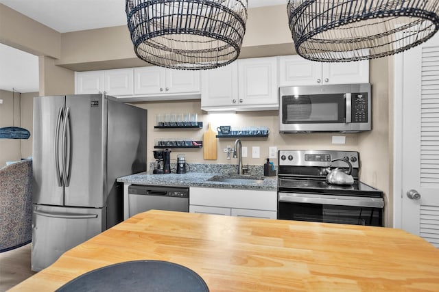 12900 Walden Rd Unit 715G, Montgomery, TX 77356 - kitchen featuring stainless steel appliances, a sink, butcher block countertops, and white cabinetry