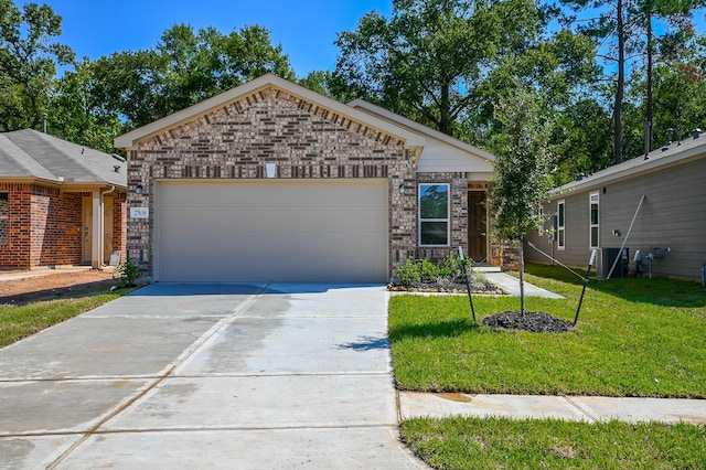 27638 Mesabe Dr, Magnolia, TX 77354 - view of front of house featuring driveway, a garage, a front lawn, and brick siding