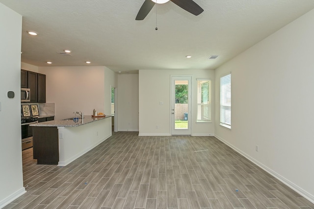 27638 Mesabe Dr, Magnolia, TX 77354 - unfurnished living room featuring recessed lighting, baseboards, and light wood finished floors
