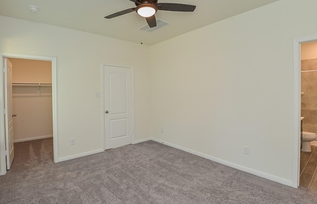 27638 Mesabe Dr, Magnolia, TX 77354 - unfurnished bedroom featuring a walk in closet, carpet flooring, and baseboards