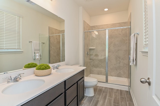 27638 Mesabe Dr, Magnolia, TX 77354 - full bath featuring a stall shower, toilet, double vanity, and wood finish floors