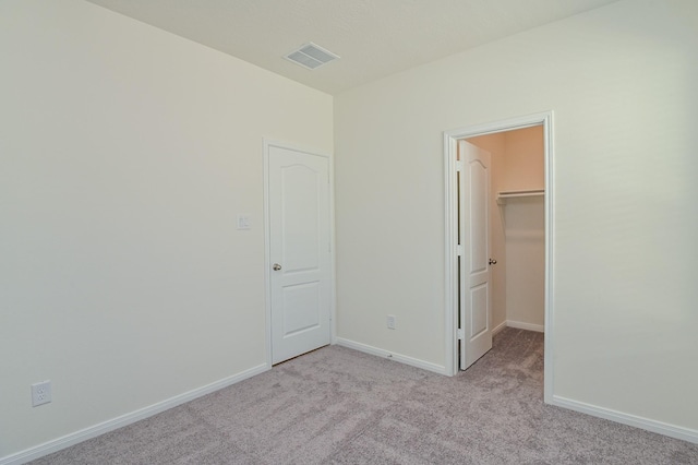27638 Mesabe Dr, Magnolia, TX 77354 - unfurnished bedroom with light carpet, a spacious closet, and baseboards