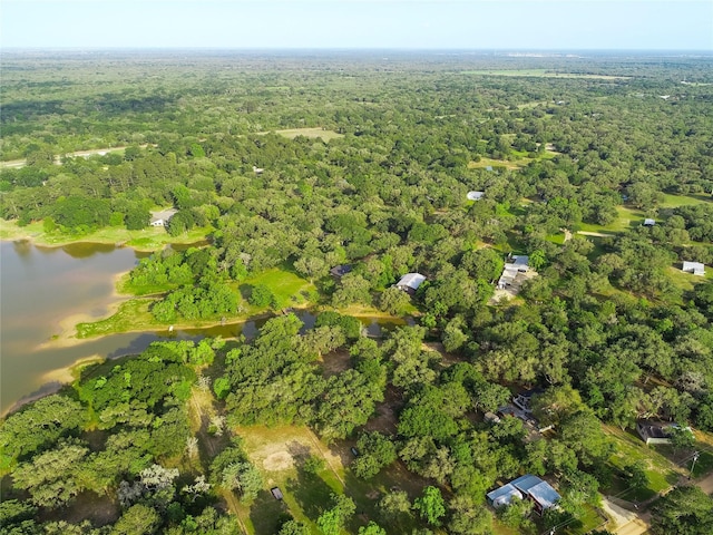 302 Bluebonnet Rd, Sheridan, TX 78950 - aerial view of property and surrounding area featuring a heavily wooded area and a large body of water