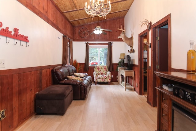 302 Bluebonnet Rd, Sheridan, TX 78950 - sitting room with wooden walls, wood ceiling, vaulted ceiling, wainscoting, and light wood-style flooring