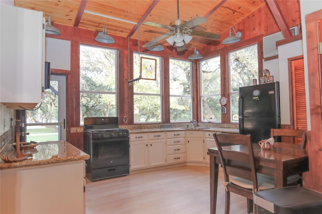 302 Bluebonnet Rd, Sheridan, TX 78950 - kitchen featuring black appliances, wooden ceiling, ceiling fan, light wood-style flooring, and light stone countertops